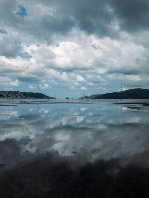 The Reflection of the Cloudy Sky on a Water Surface