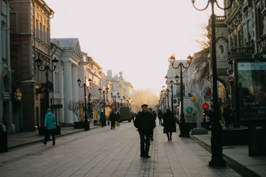 Charming twilight view of a historic street with pedestrians in Nizhny Novgorod, Russia.