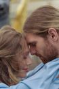 Man in Blue Dress Shirt Kissing Womans Cheek