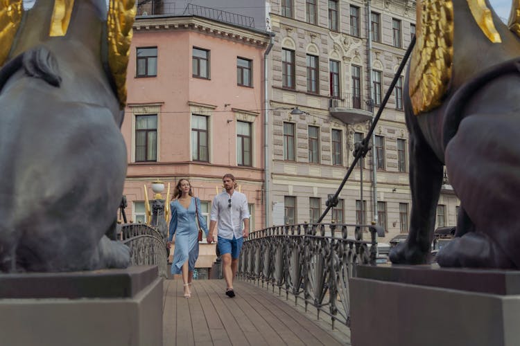 A Couple Walking On The Bridge