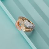 Gold signet rings on a pale green surface, photo by The Glorious Studio on Pexels