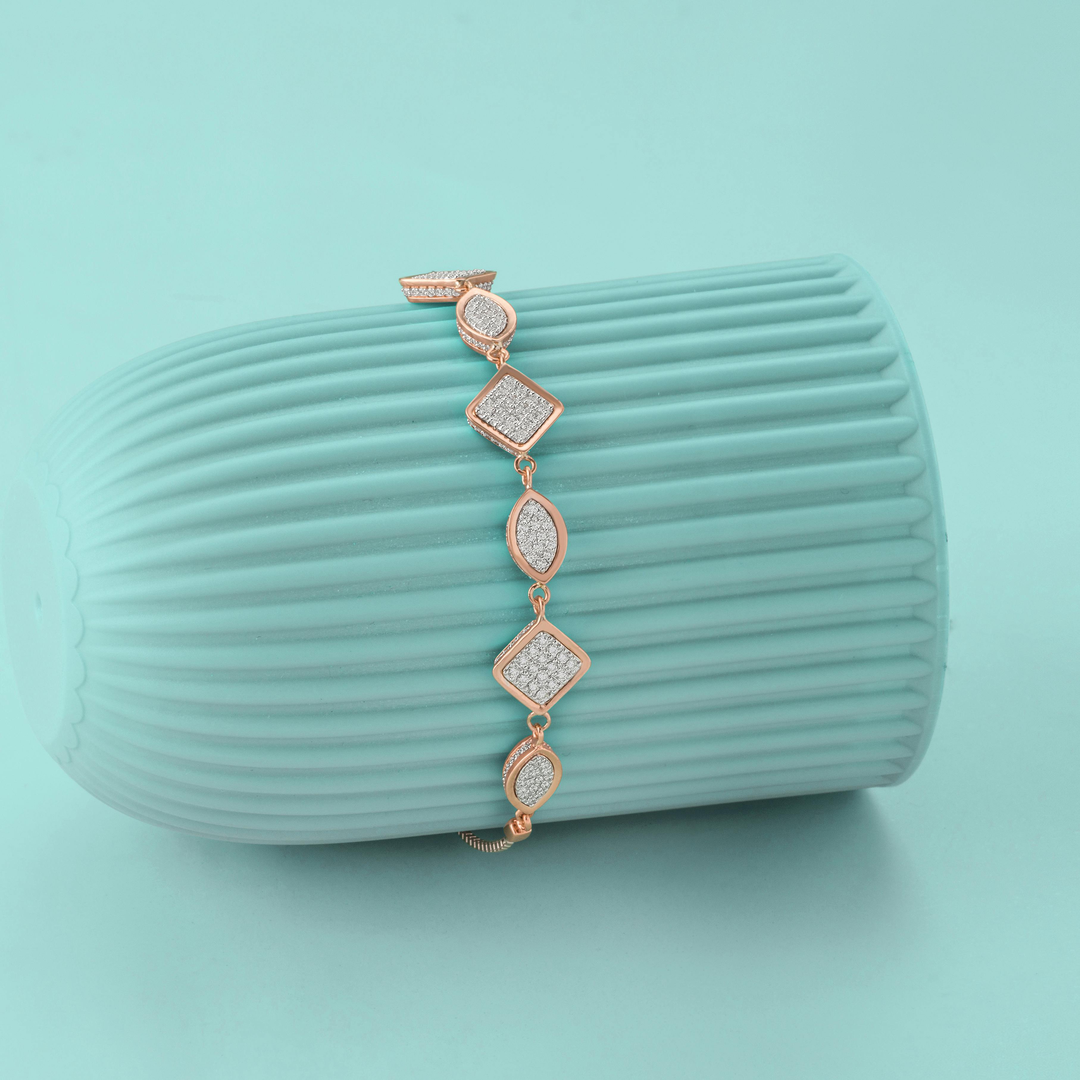 Luxurious diamond bracelet elegantly displayed on a stylish teal background, perfect for fashion and jewelry themes.