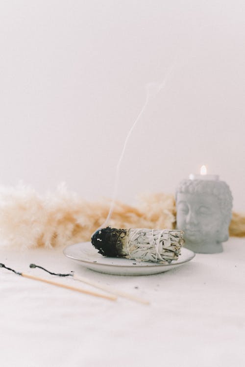 Smoking Incense by Buddha Candlestick 