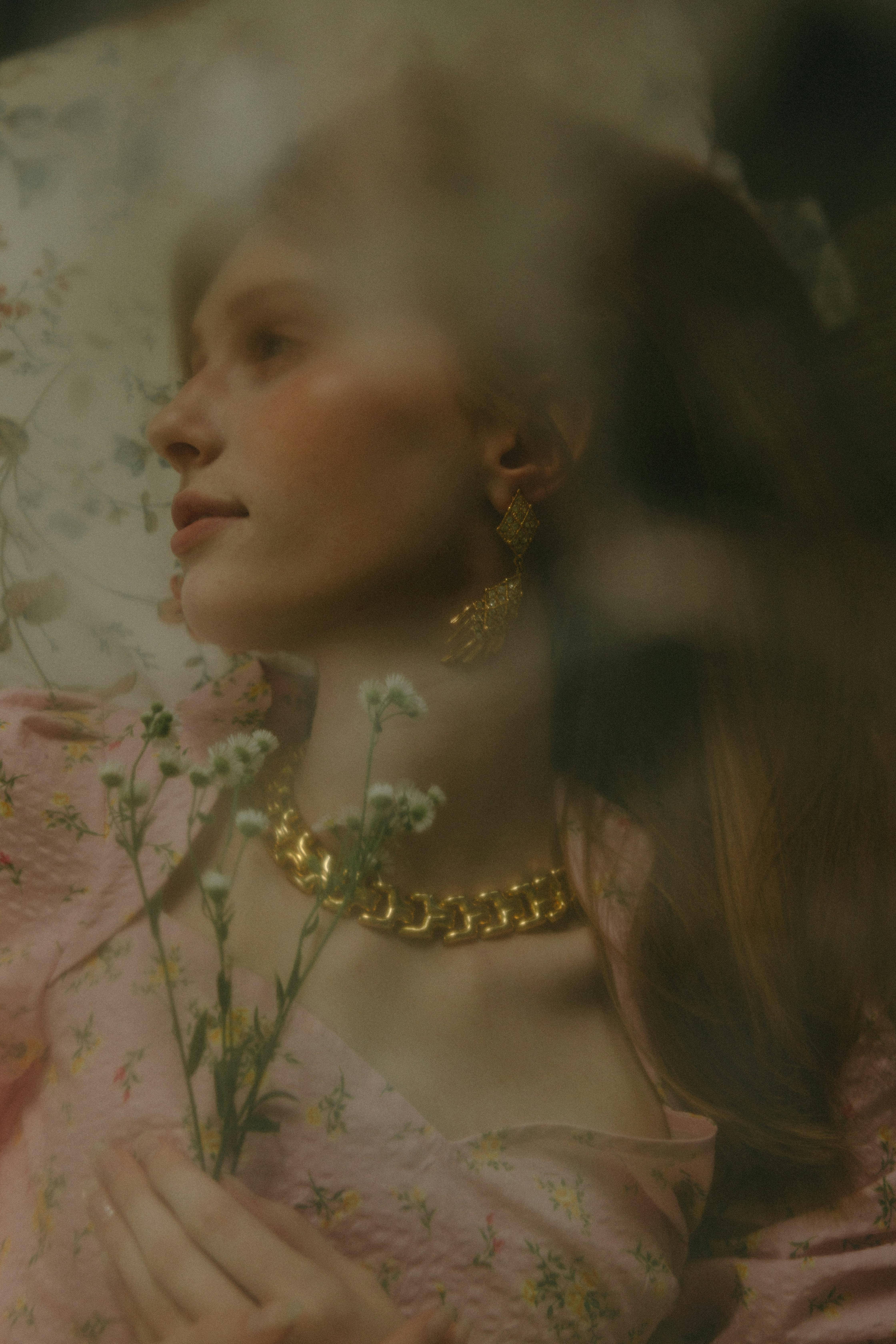 woman in floral dress wearing golden jewelries