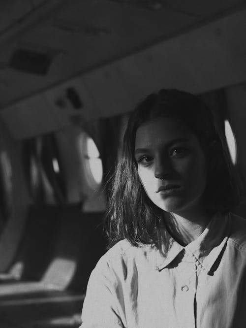 Black and White Photo of a Woman in the Dark