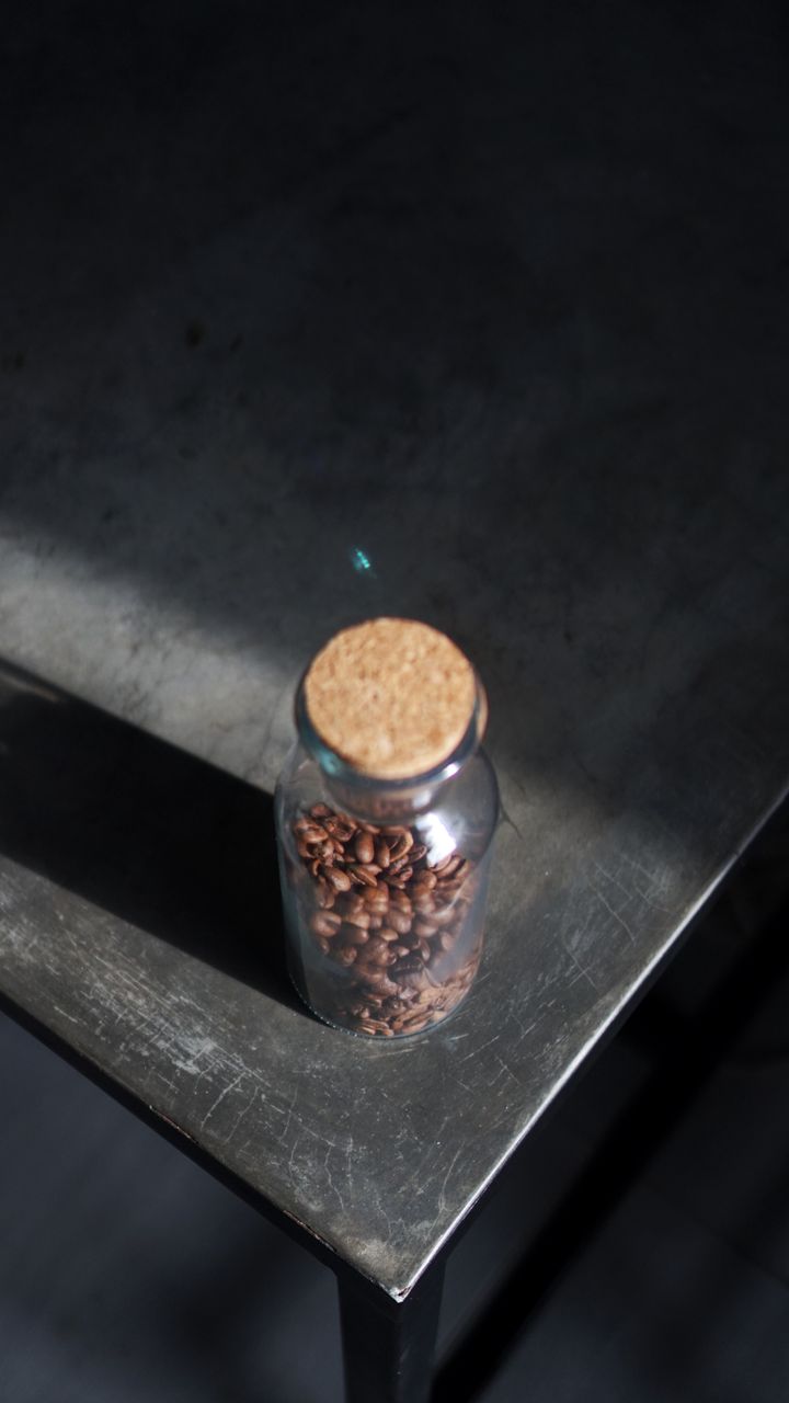 clear glass airtight canisters holding coffee beans on a kitchen coffee bar