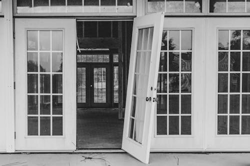 Grayscale Photo of Glass Doors 