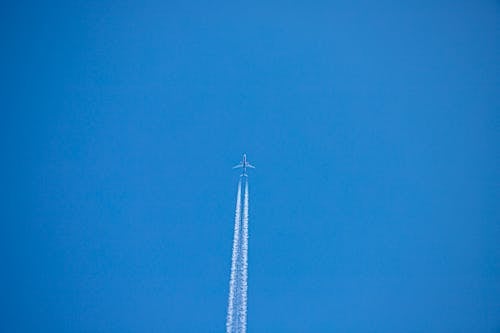 Airplane Flying Under Blue Sky