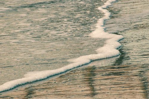Free Gentle sea foam meets the shore at Sunset Beach, North Carolina, capturing serene coastal beauty. Stock Photo