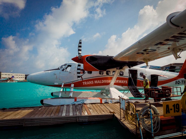 A Seaplane In The Dock By The Wooden Pier