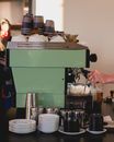 Person Holding Green and Silver Coffee Maker