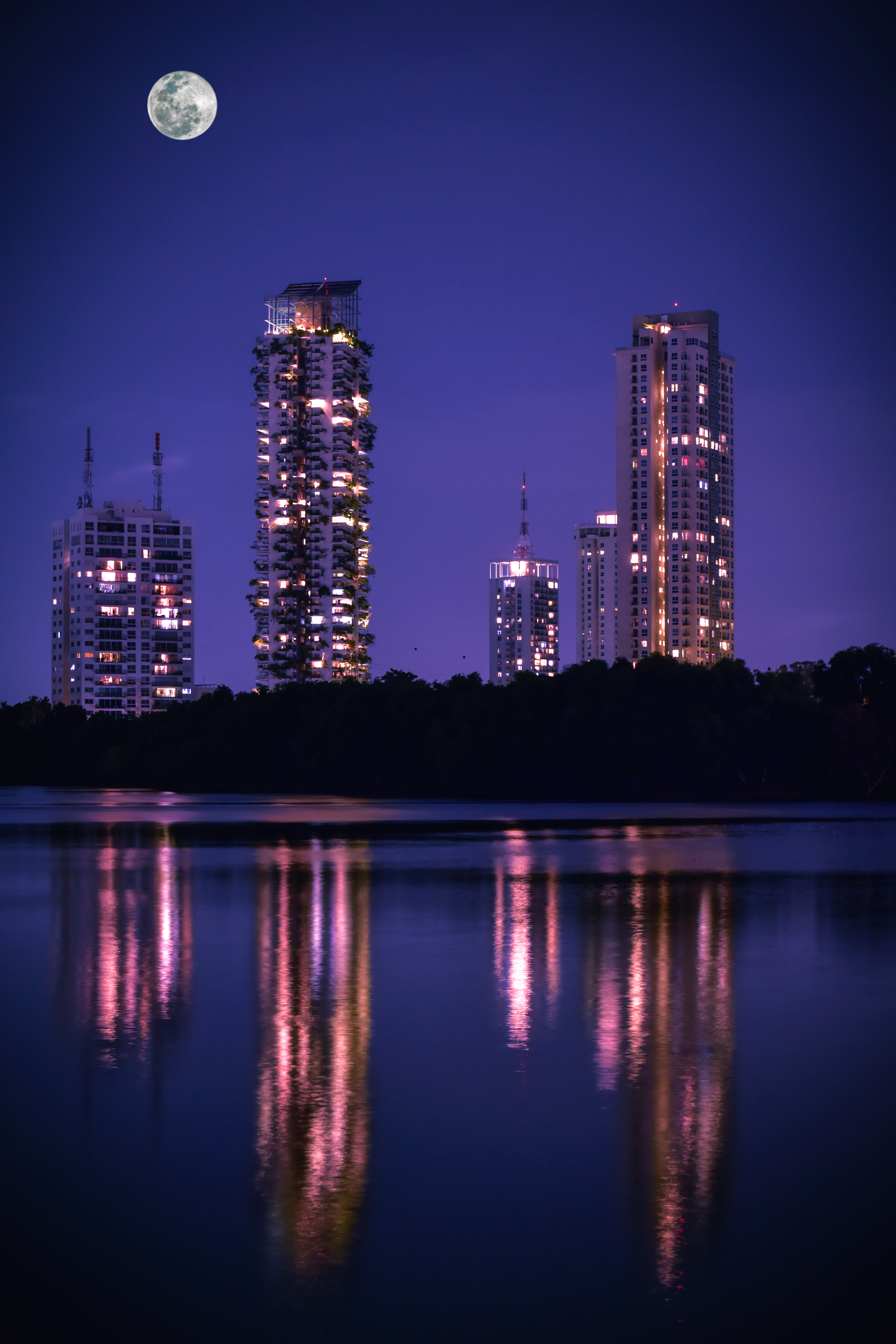 City Skyline Across Body of Water during Night Time · Free Stock Photo