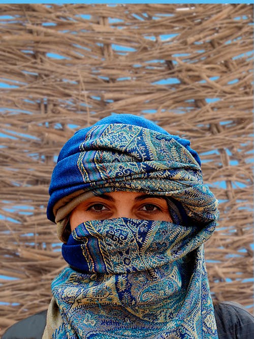 Person Wearing Blue and Brown Hijab Veil