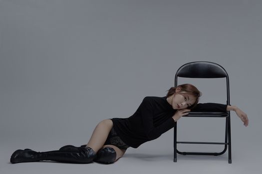 A Woman Leaning on a Chair