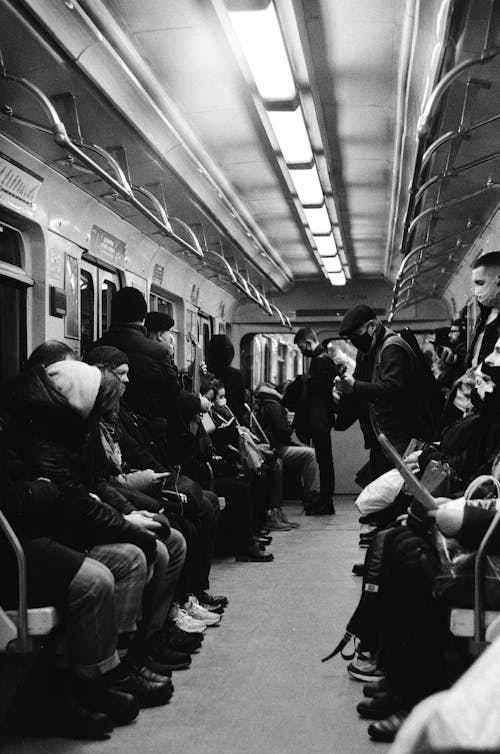Grayscale Photo of People Inside on Train