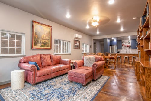 Spacious Living Room With Leather Couch and Wooden Flooring