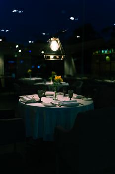 An elegantly set table in a dimly lit Moscow restaurant at night, ideal for fine dining.