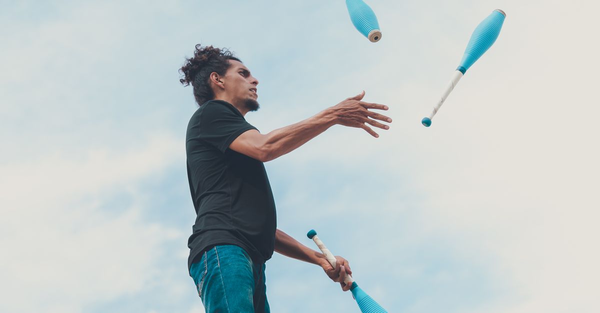person juggling multiple colored balls with a focused expression, representing balancing multiple profiles