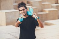 Man in Black Crew Neck T-shirt Holding Blue and White Plastic Toy