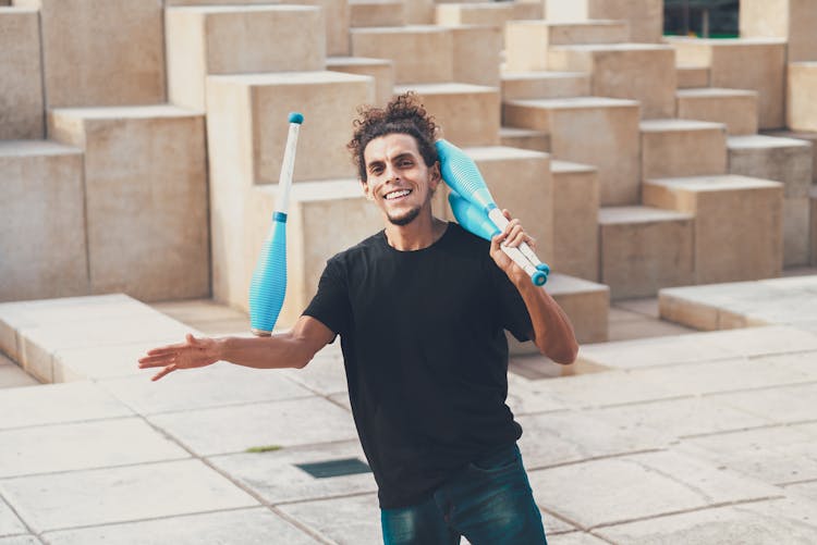 A Man In Black Shirt Juggling