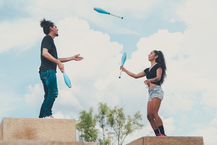 Man And Woman Juggling Together