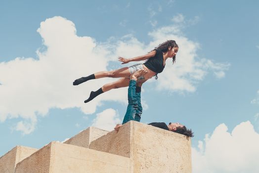 A Man Lifting a Woman with His Feet