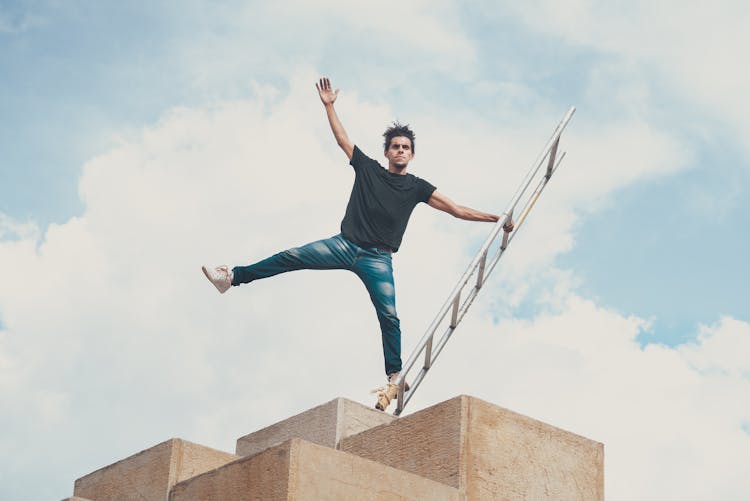 A Man Balancing On A Ladder