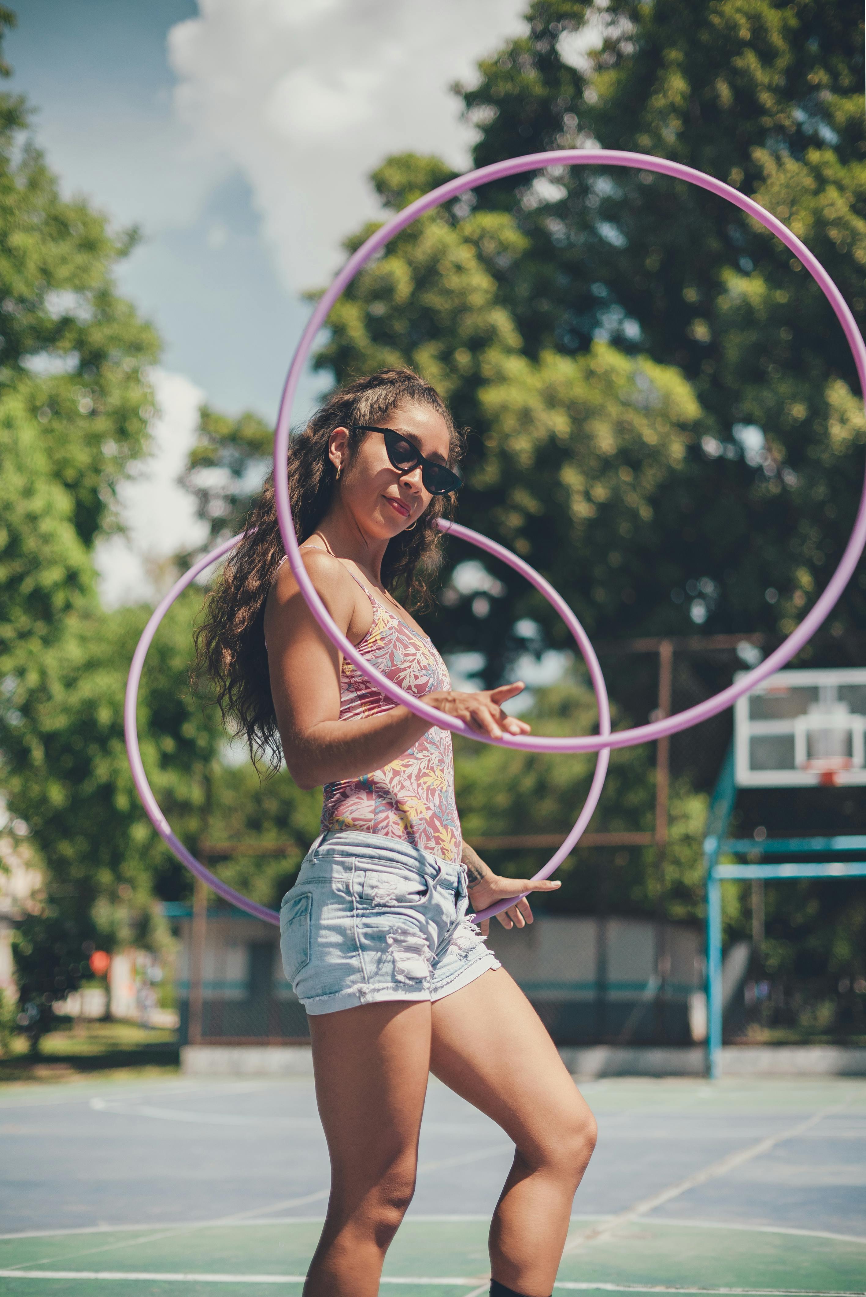 a woman using pink hula hoops