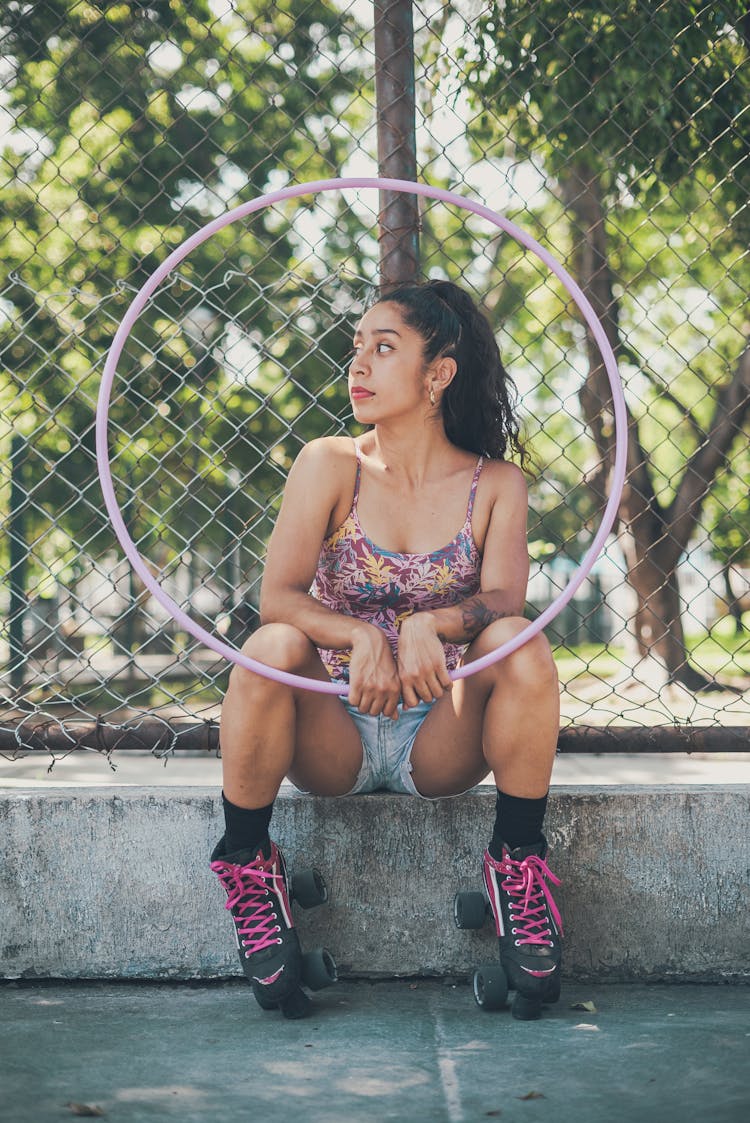 A Sitting Woman Holding A Hula Hoop