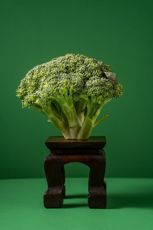 A Green Broccoli on a Wooden Table