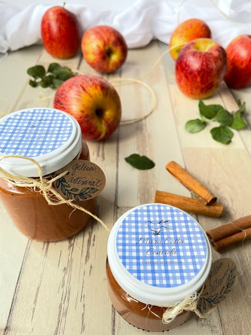 Jam in Glass Jars Near Red Apples on a Wooden Surface