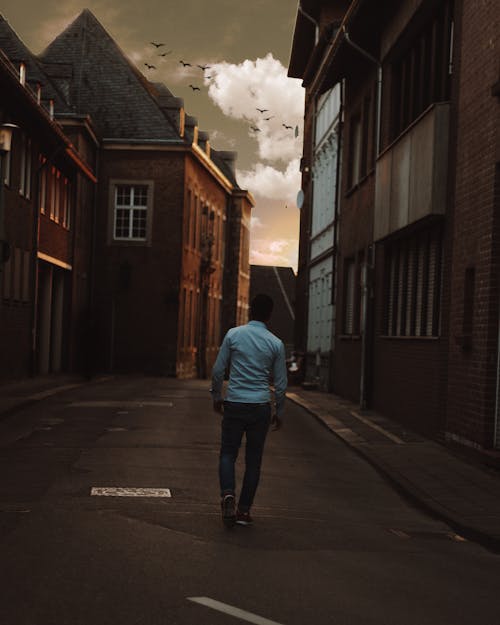Free Man Walking Alone in the Street of Town Stock Photo