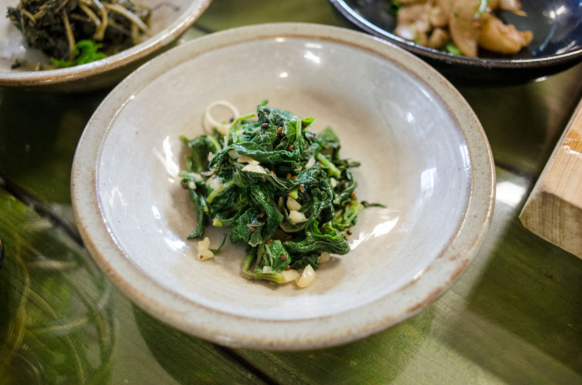 Close-up of a freshly prepared Asian vegetable dish in an earthenware bowl, perfect for food photography enthusiasts.
