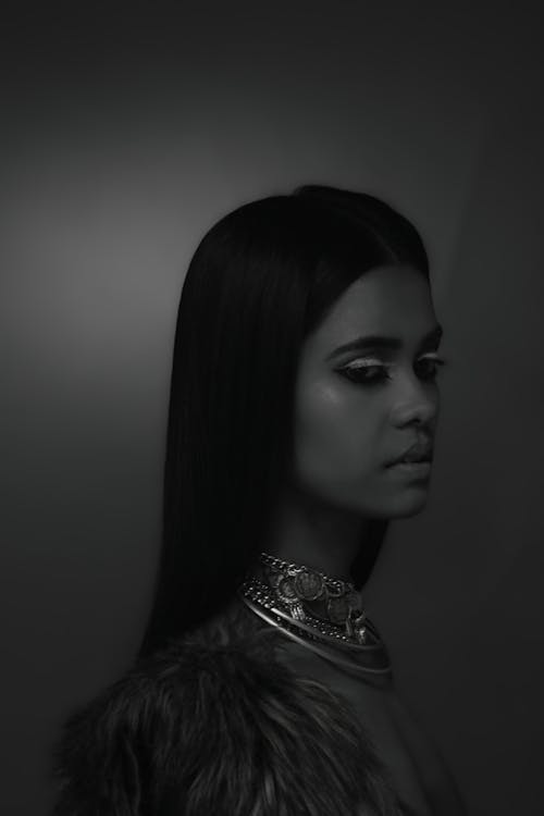 Grayscale Photo of a Woman with Necklaces