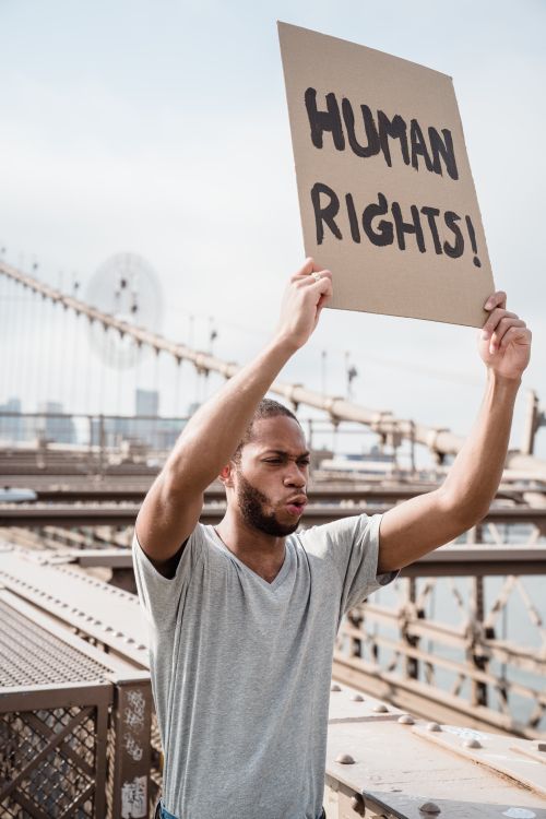 Human Rights Smiling A Man Shouting while Holding a Human Rights Placard · Free Stock Photo