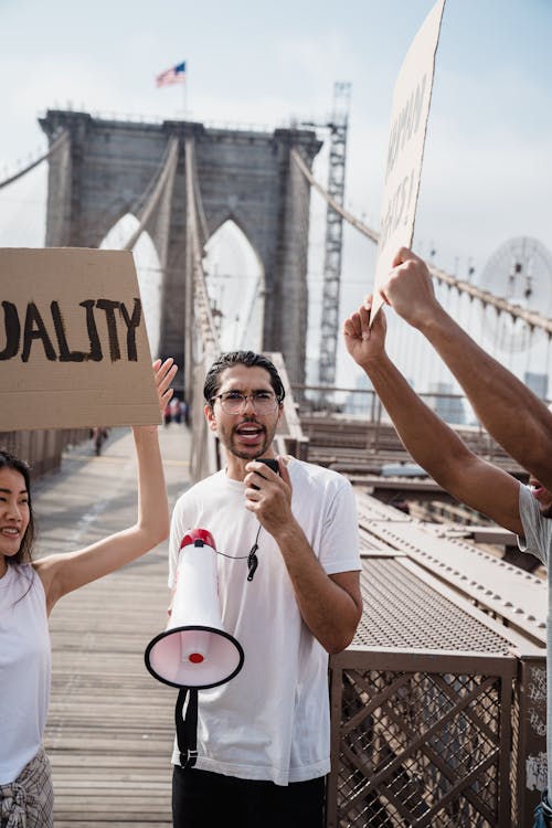 Free Man in a White Shirt Holding a Megaphone Stock Photo