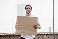 Man Holding a Blank Placard