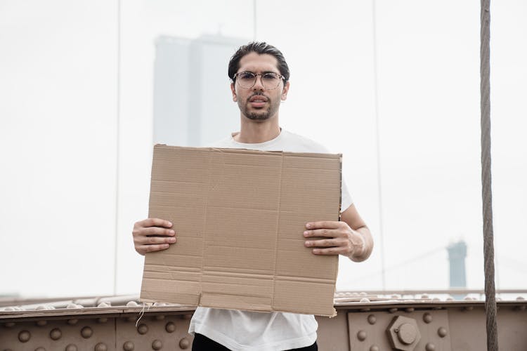 Man Holding A Blank Placard