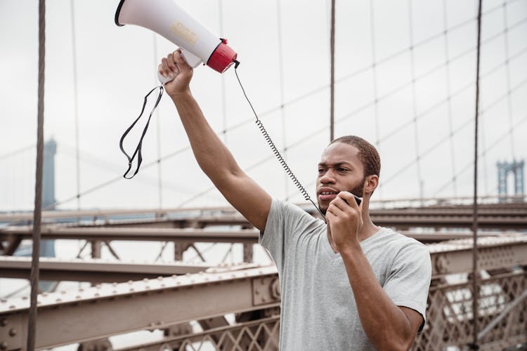 Protester In White Crew Neck Holding Megaphone