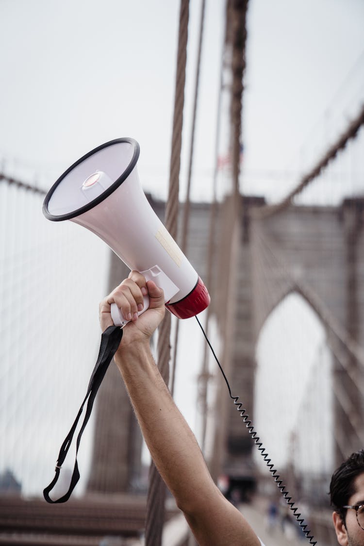 Person Holding White And Red Megaphone