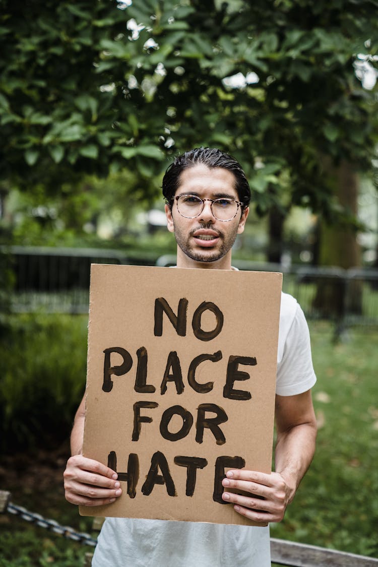 A Man Holding A Placard 