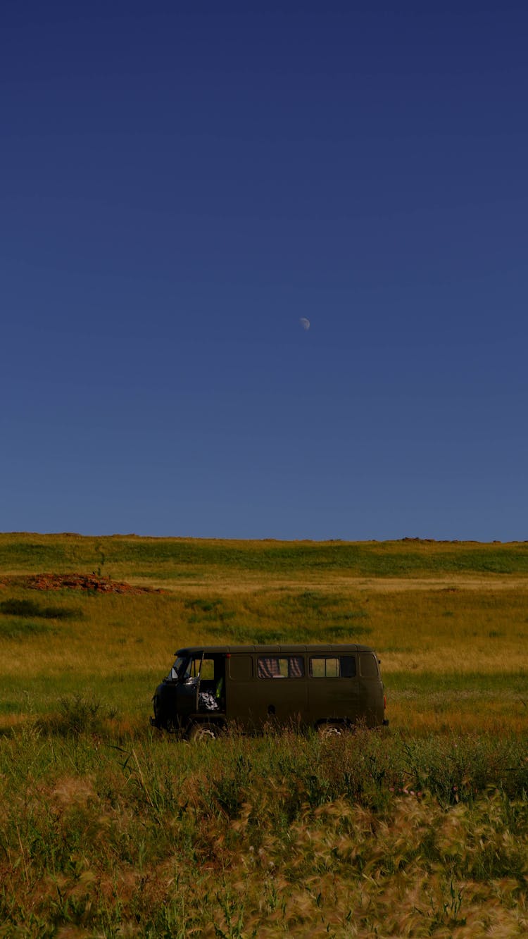 Van Parked In A Grassland 