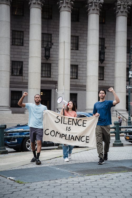 Free Protesters Holding a Banner with a Slogan Stock Photo