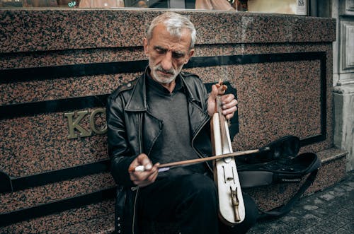Free An Elderly Man Playing a Kemence of the Black Sea Stock Photo