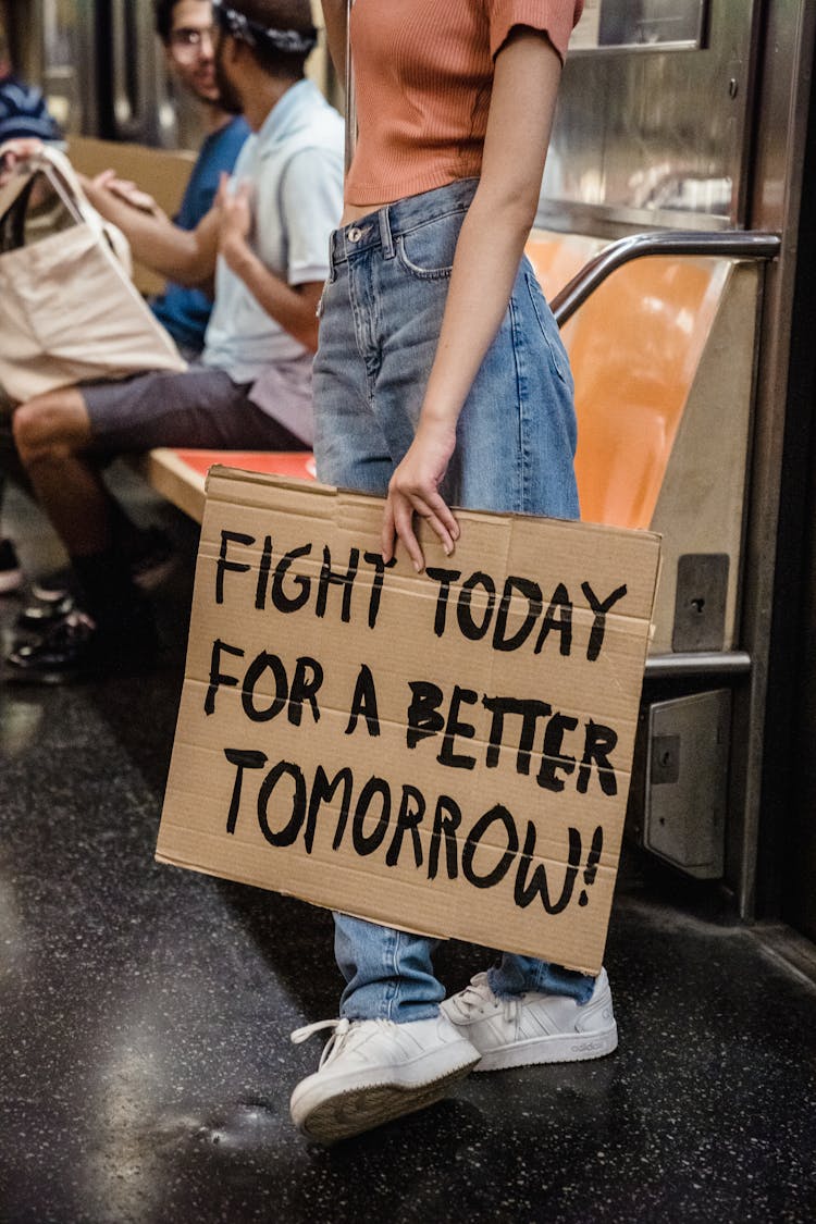 A Person Holding A Cardboard With Texts