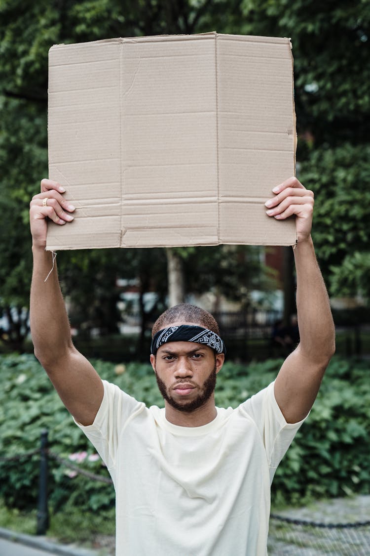 Man Holding A Blank Cardboard