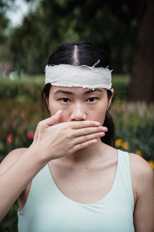 Free Woman covering her Mouth with her Hand Stock Photo