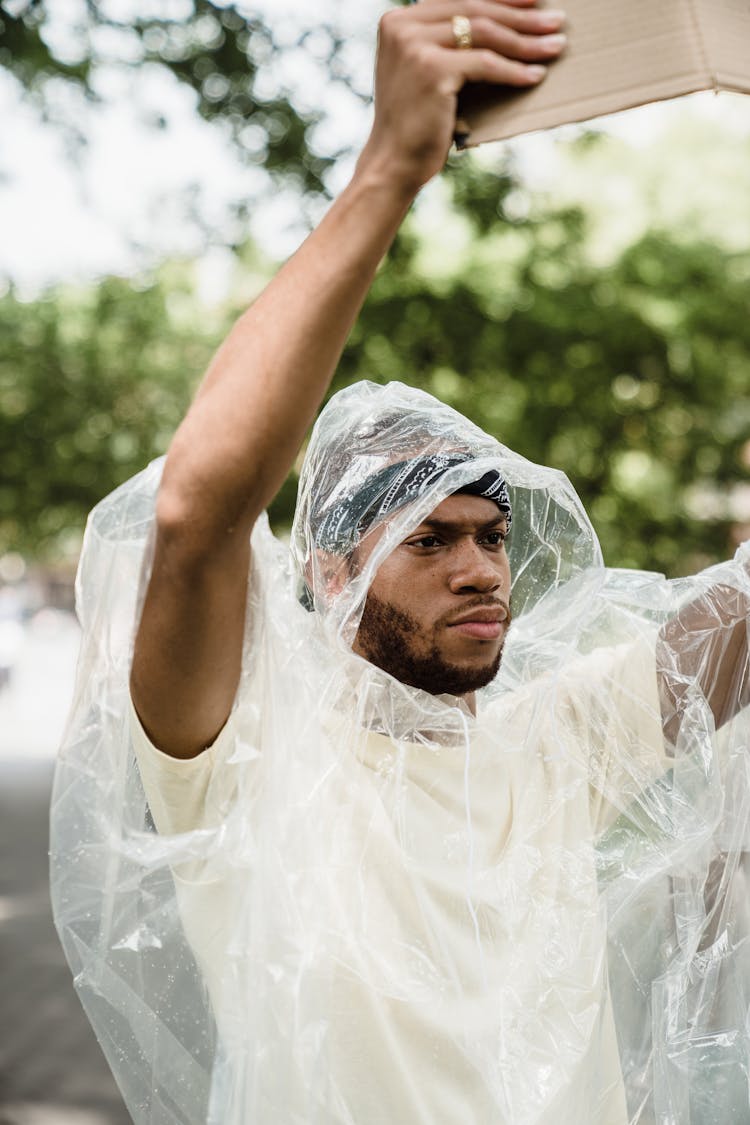 A Man Wearing A Transparent Raincoat