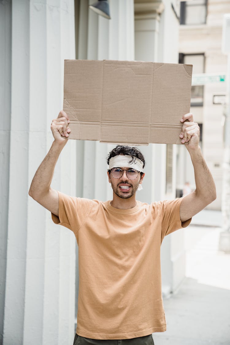 A Man Wearing A Bandana Protesting