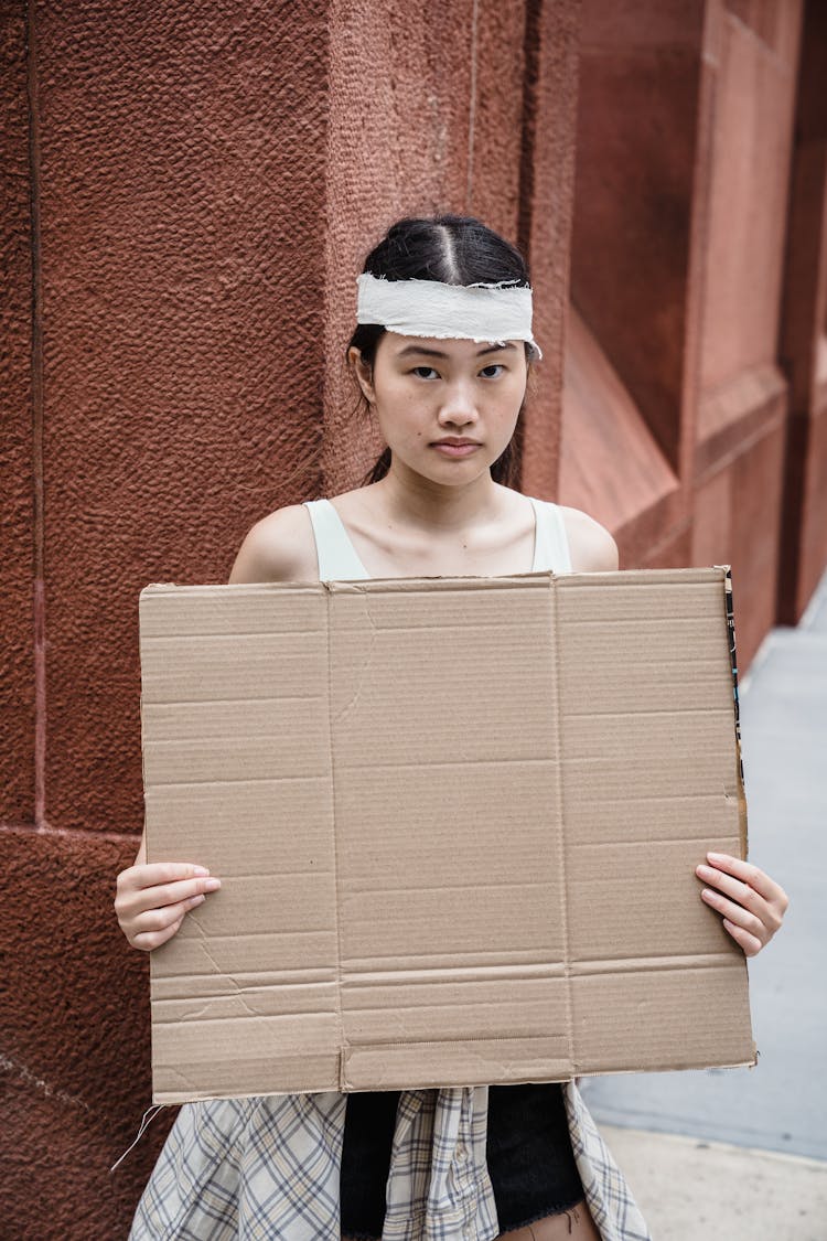 Woman With Mockup Placard On Street